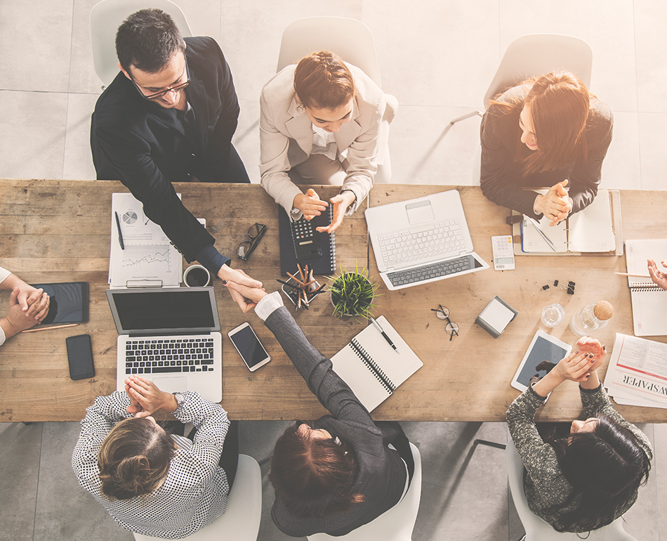 Group of business people meeting around a table, view is from above looking down